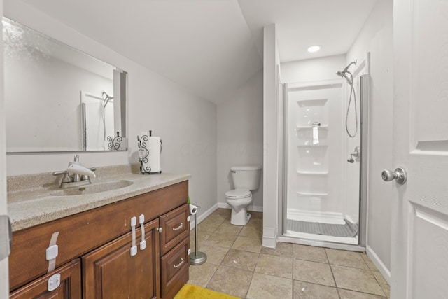 bathroom with toilet, a shower stall, tile patterned flooring, and vanity