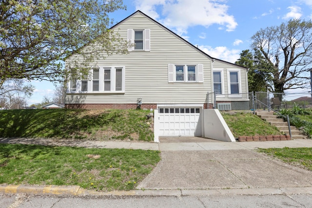 view of front of home with an attached garage, driveway, fence, and a gate