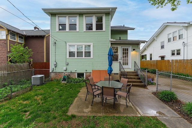 rear view of house featuring central AC unit, entry steps, a patio area, and a lawn