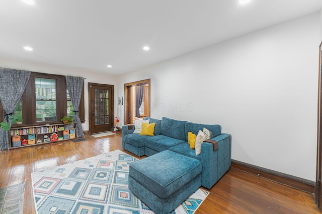 living area with baseboards, recessed lighting, and hardwood / wood-style flooring