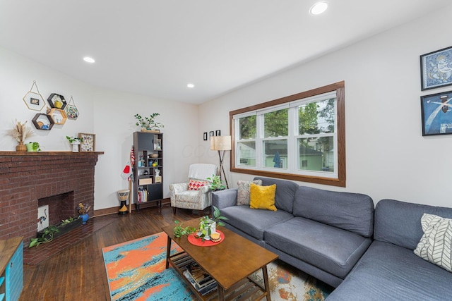 living room with wood-type flooring, a brick fireplace, and recessed lighting