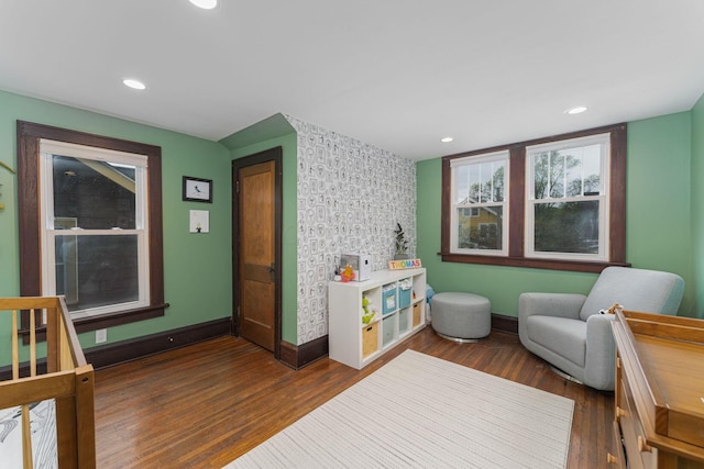 interior space featuring baseboards, recessed lighting, an accent wall, and dark wood-type flooring