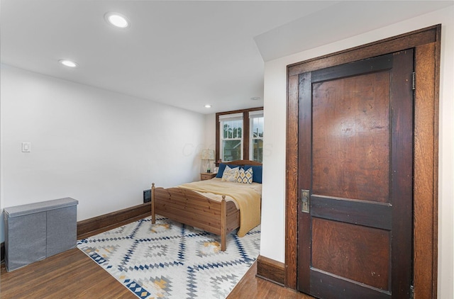 bedroom with recessed lighting, baseboards, and wood finished floors