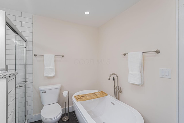 bathroom featuring recessed lighting, toilet, baseboards, tiled shower, and a freestanding bath