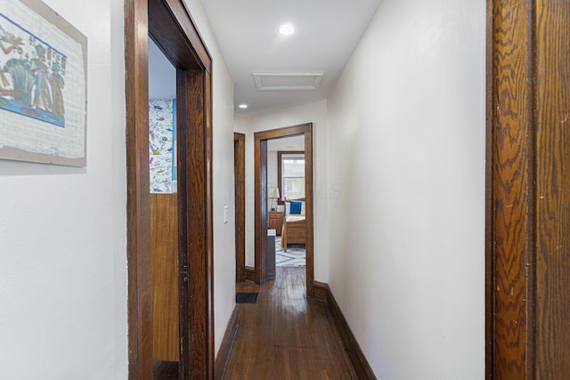 hallway featuring attic access, baseboards, dark wood-style floors, and recessed lighting