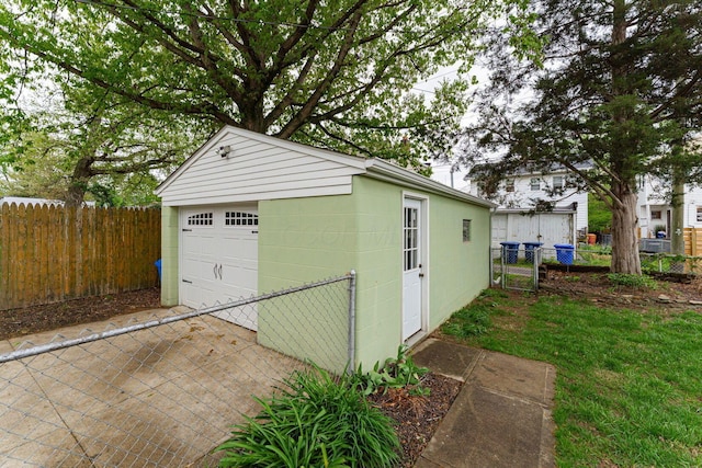 detached garage featuring fence