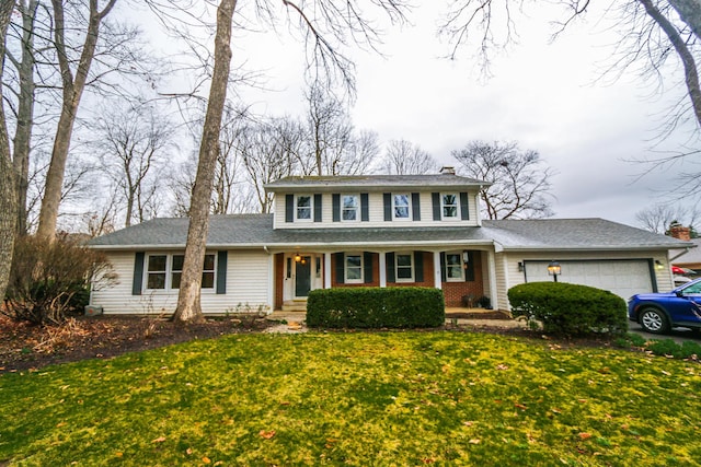 view of front facade with a front yard and a garage