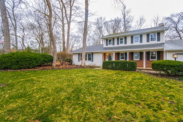 view of front of house with brick siding and a front yard