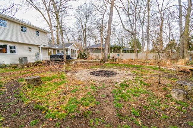 view of yard with cooling unit and fence