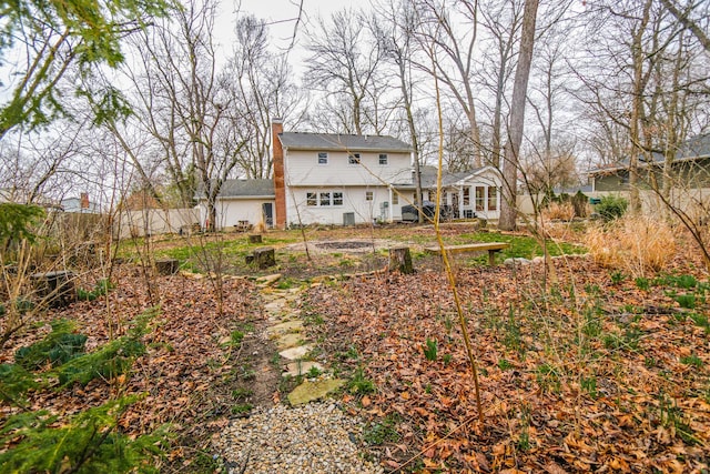 back of property with a chimney
