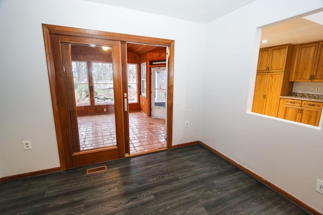 unfurnished room with dark wood finished floors, french doors, visible vents, and baseboards