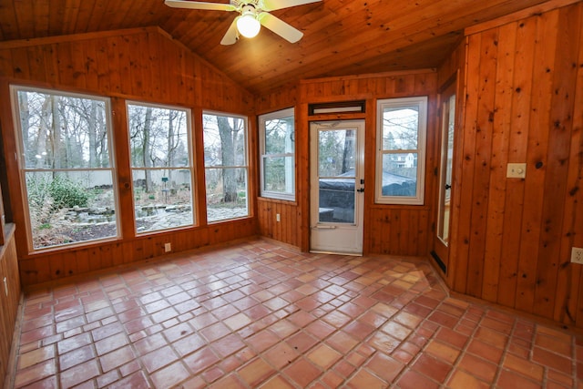 unfurnished sunroom with wood ceiling, lofted ceiling, a healthy amount of sunlight, and ceiling fan