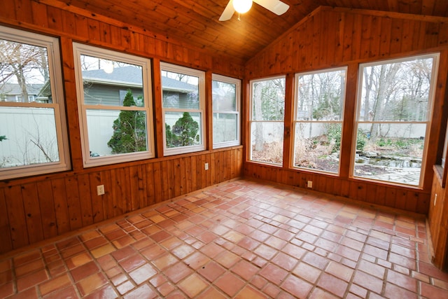 unfurnished sunroom featuring a healthy amount of sunlight, a ceiling fan, and lofted ceiling
