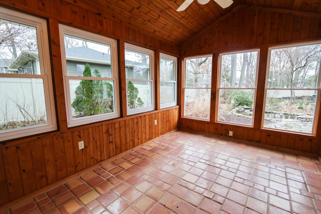 unfurnished sunroom with a ceiling fan and vaulted ceiling