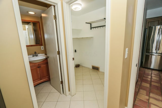 bathroom featuring tile patterned flooring, vanity, and visible vents