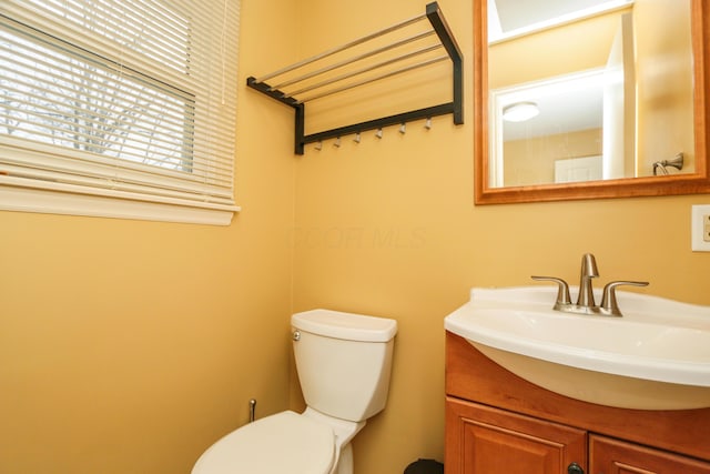 bathroom with toilet and vanity