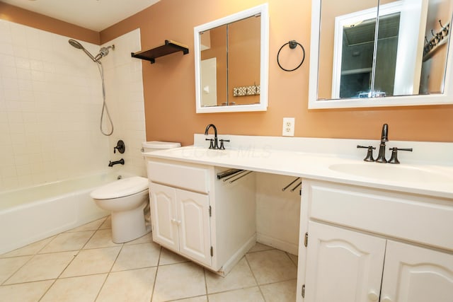 bathroom with tile patterned floors, toilet, double vanity, and a sink