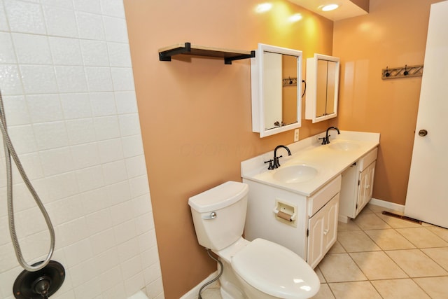 bathroom featuring a sink, toilet, double vanity, and tile patterned floors