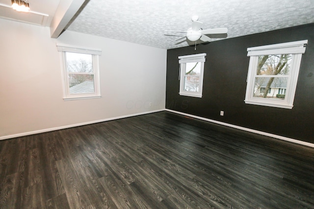 empty room with baseboards, plenty of natural light, and a textured ceiling