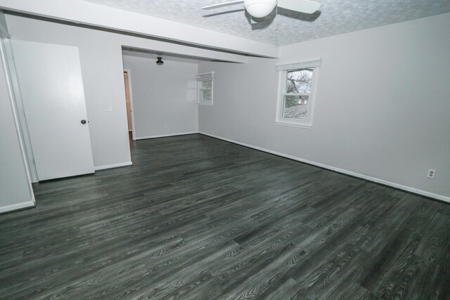 unfurnished room featuring dark wood-style floors, baseboards, a textured ceiling, and ceiling fan
