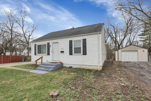 1333 Carolyn Ave, Columbus, OH 43224 - bungalow-style home with an outbuilding, a detached garage, a front yard, fence, and driveway
