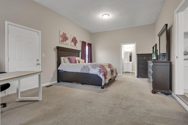 1333 Carolyn Ave, Columbus, OH 43224 - bedroom with baseboards, light colored carpet, a textured ceiling, and connected bathroom