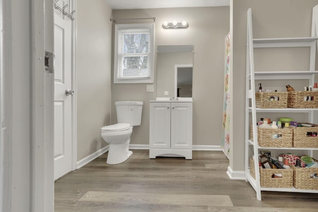 1333 Carolyn Ave, Columbus, OH 43224 - bathroom featuring vanity, baseboards, toilet, and wood finished floors