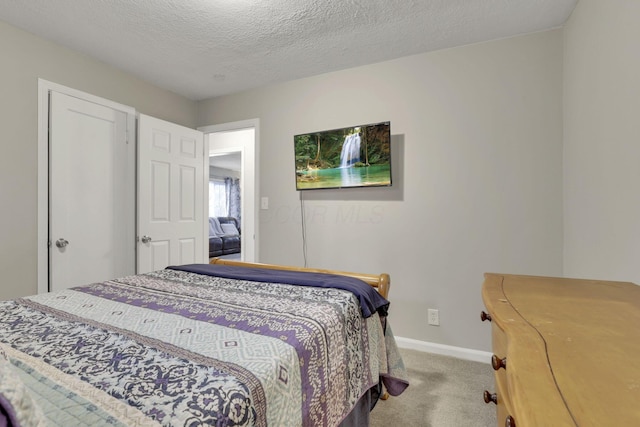 1333 Carolyn Ave, Columbus, OH 43224 - bedroom featuring a textured ceiling, carpet flooring, and baseboards