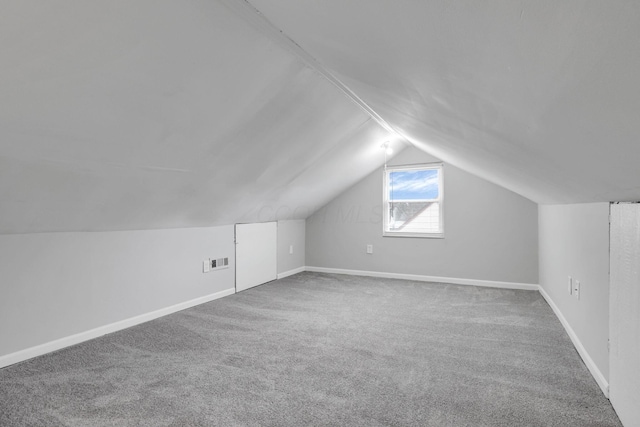 1333 Carolyn Ave, Columbus, OH 43224 - bonus room featuring baseboards, lofted ceiling, carpet, and visible vents