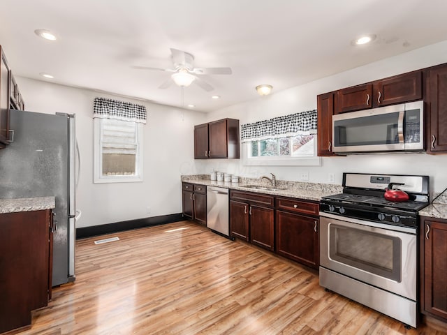 kitchen with a healthy amount of sunlight, ceiling fan, appliances with stainless steel finishes, and a sink