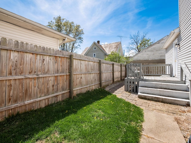 view of yard with a wooden deck and fence