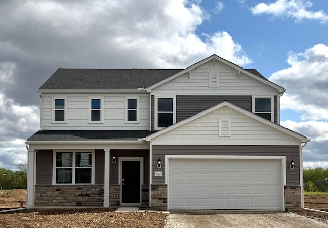 view of front of house featuring driveway, stone siding, a shingled roof, and a garage