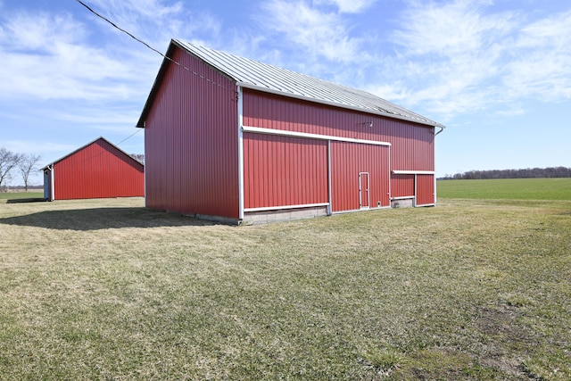 view of pole building with a yard