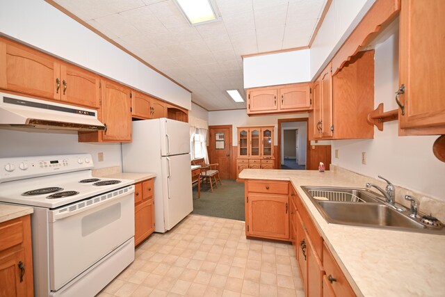 kitchen with crown molding, under cabinet range hood, light countertops, white appliances, and a sink