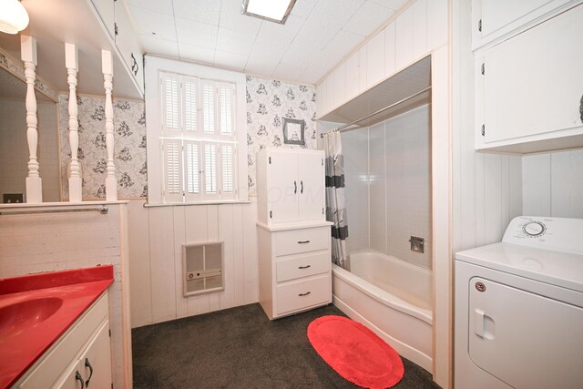 full bathroom with heating unit, washer / clothes dryer, vanity, and shower / tub combo with curtain