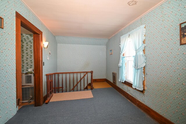 hallway featuring wallpapered walls, crown molding, an upstairs landing, and carpet floors
