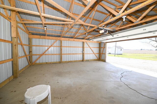 garage featuring metal wall and a garage door opener
