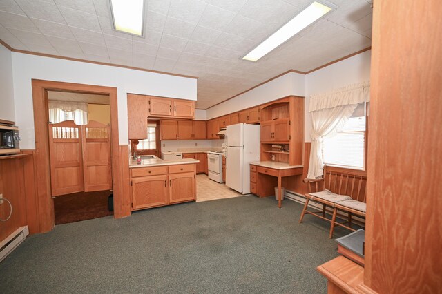 kitchen featuring a baseboard heating unit, light colored carpet, light countertops, ornamental molding, and white appliances