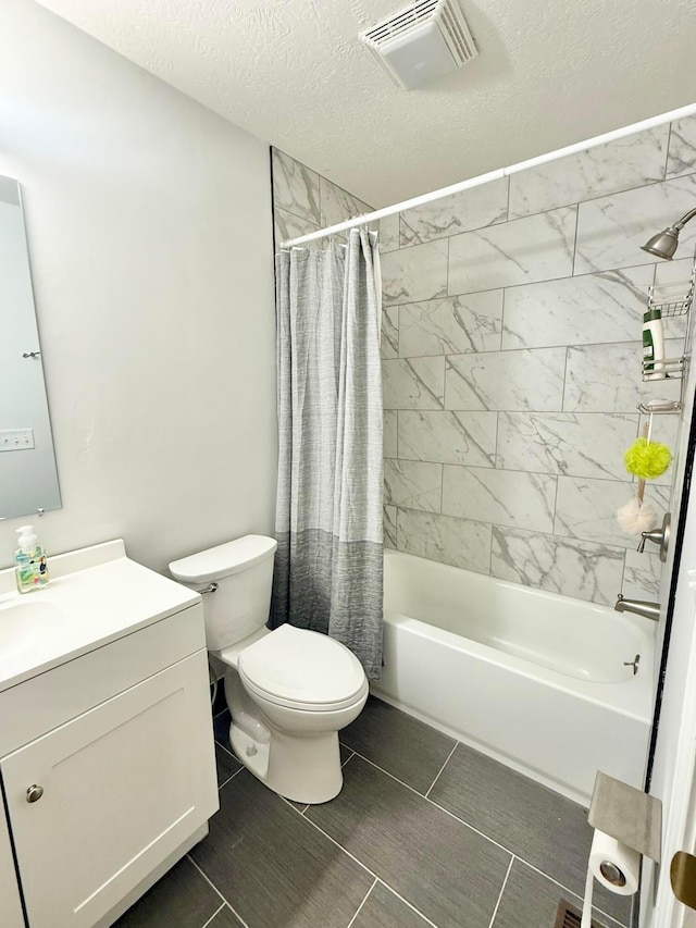 bathroom with vanity, shower / bath combo with shower curtain, toilet, a textured ceiling, and visible vents