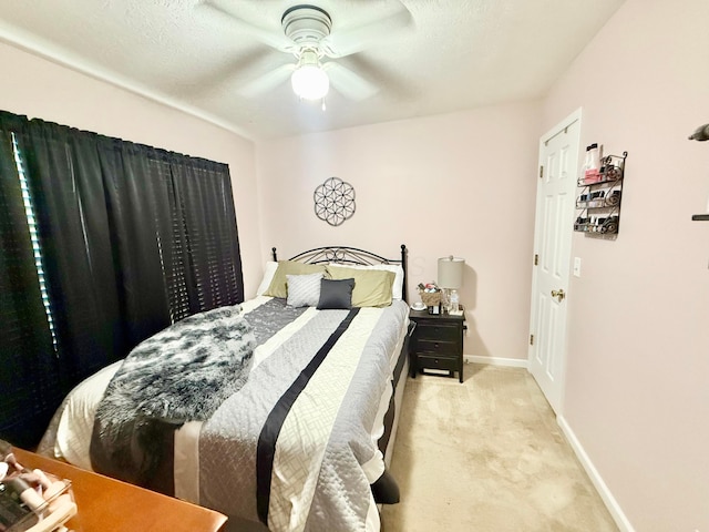 bedroom featuring baseboards, a ceiling fan, and carpet