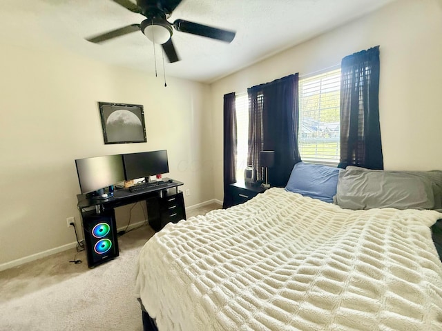 carpeted bedroom with baseboards and a ceiling fan