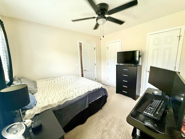 bedroom featuring light carpet and a ceiling fan