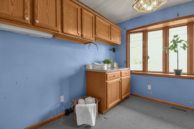 bar with light colored carpet, an inviting chandelier, visible vents, and baseboards