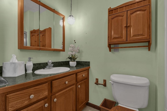 bathroom featuring toilet and vanity