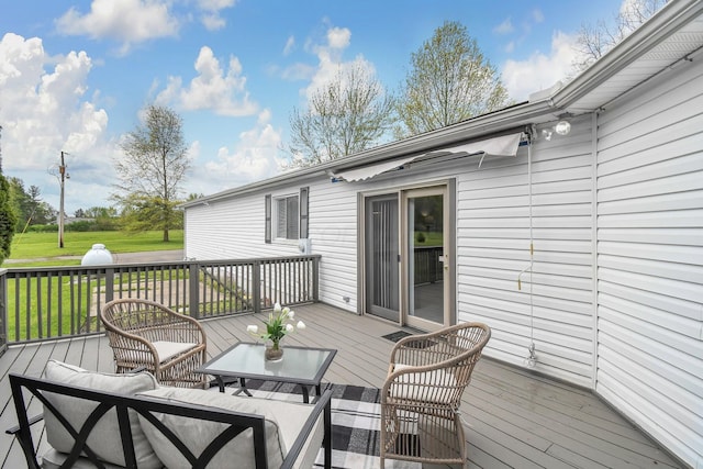 wooden deck featuring outdoor lounge area and a yard