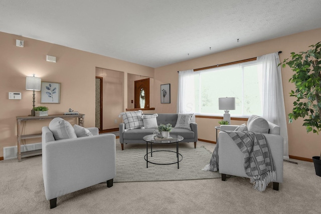 carpeted living room featuring baseboards and visible vents