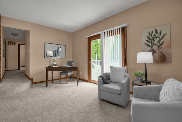 carpeted living area with baseboards and visible vents