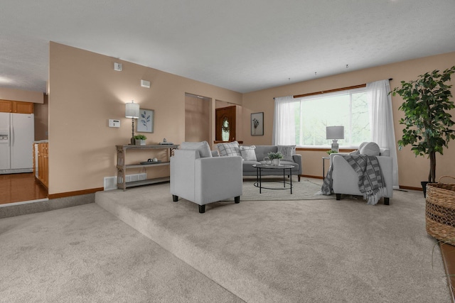living area featuring baseboards and light carpet