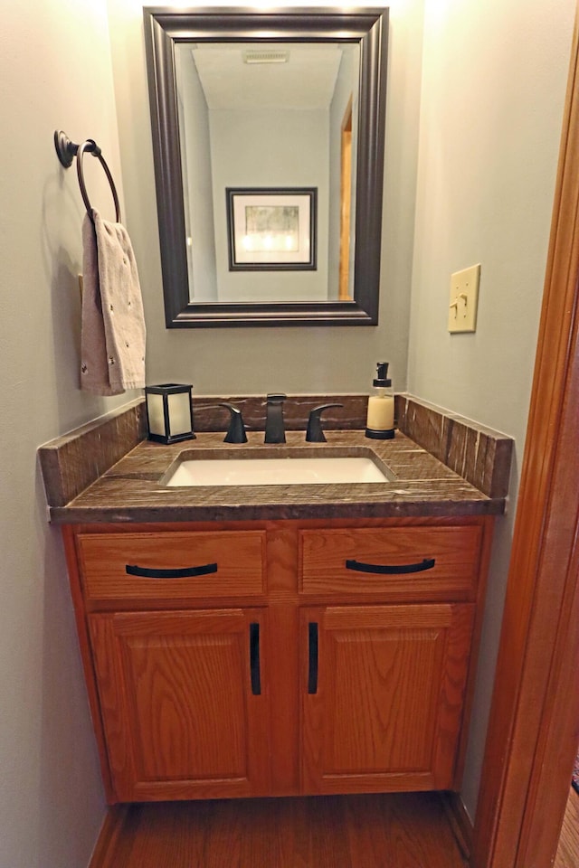 bathroom featuring vanity and wood finished floors
