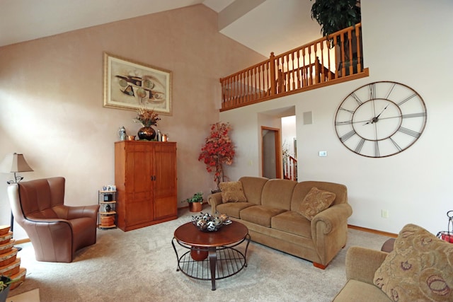 carpeted living area featuring high vaulted ceiling and baseboards